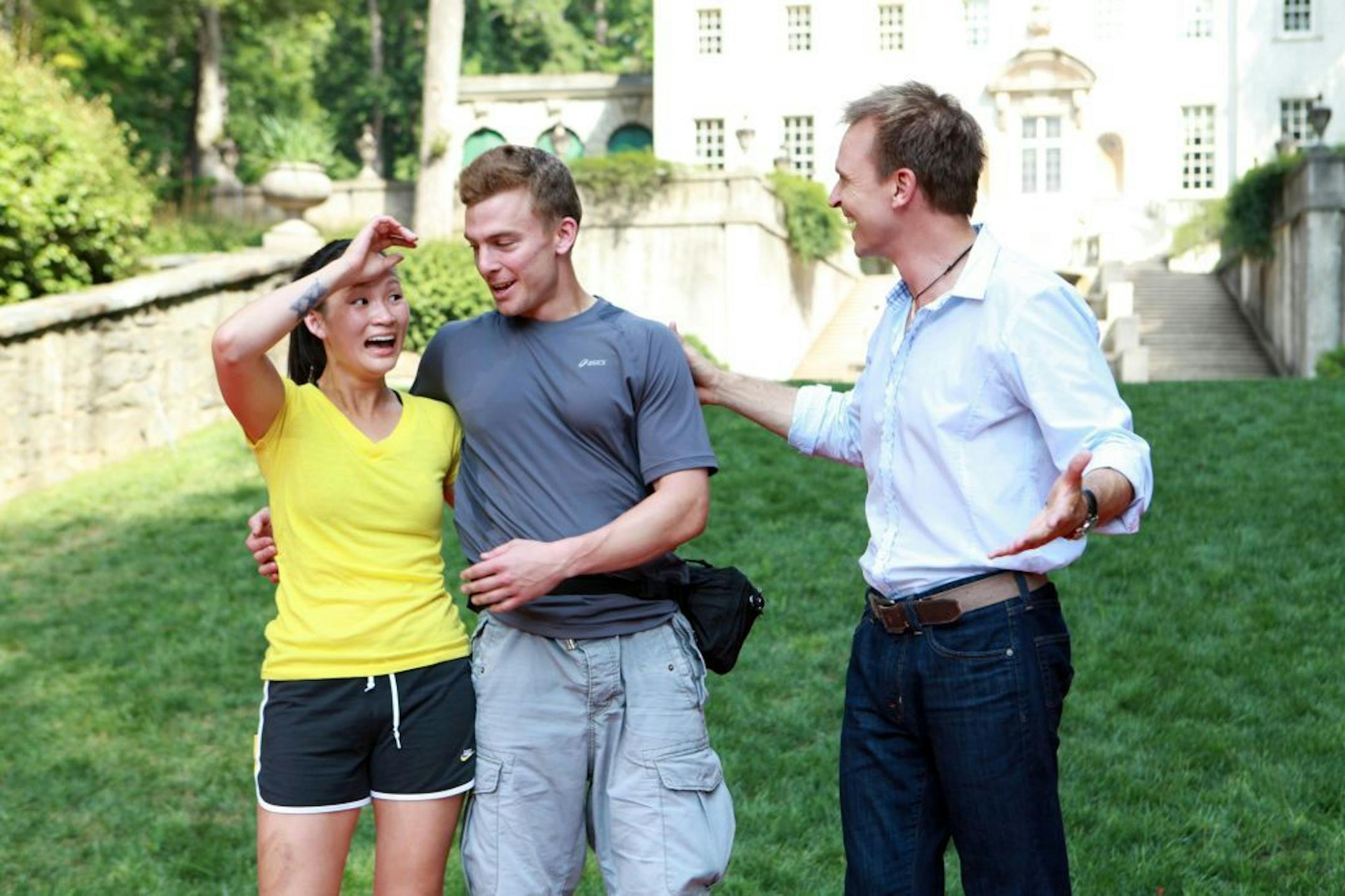 In this undated photo provided by CBS, host Phil Keoghan, right, greets engaged couple Cindy Chiang and Ernie Halvorsen, winners of the 19th installment of "The Amazing Race," in Atlanta. The finale aired Sunday, Dec. 11, 2011. (AP Photo/CBS, Sonja Flemming) MANDATORY CREDIT