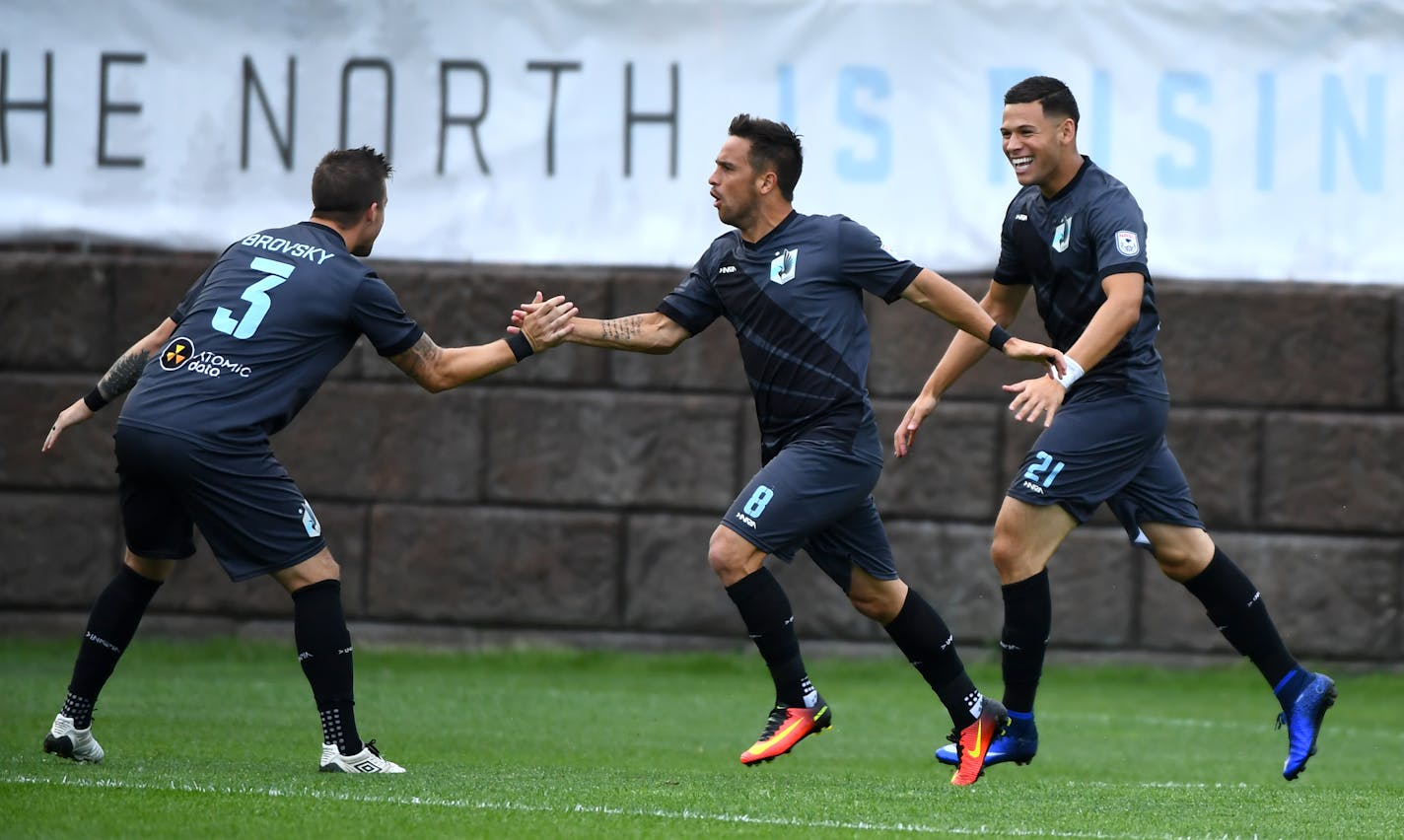 Minnesota United FC defender Jeb Brovsky (3), forward Danny Cruz (8) and forward Christian Ramirez (21) celebrated a penalty kick by Ramirez early in the first half Saturday. ] (AARON LAVINSKY/STAR TRIBUNE) aaron.lavinsky@startribune.com Minnesota United F.C. played the Indy Eleven on Saturday, July 16, 2016 at the National Sports Center in Blaine, Minn.