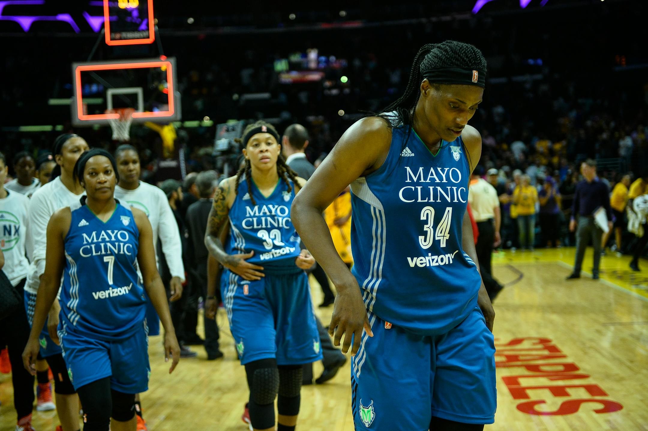 Lynx players, including forward Maya Moore, walk back to the locker room following a 75-64 loss against the Los Angeles Sparks in Game 3 of the WNBA Finals