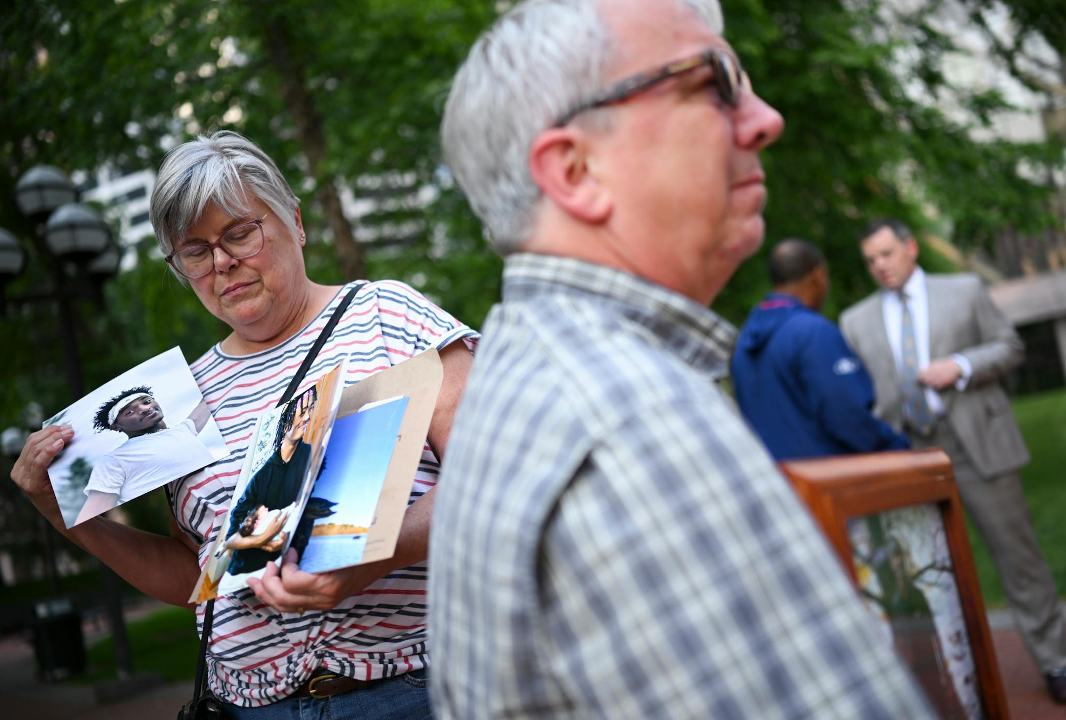 Cindy and Mark Sundberg, whose son, Tekle Sundberg, was shot and killed by Minneapolis Police during a standoff last year, held photos of their son before a rally outside the Hennepin County Government Center Friday, June 16, 2023, in Minneapolis, Minn. The US Department of Justice released the findings in its sweeping investigation into the Minneapolis Police Department finding it routinely engaged in a pattern of racist and abusive behavior.