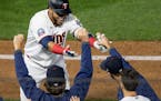 A teammates reached out with hand sanitizer to Minnesota Twins DH Nelson Cruz as he celebrated after the game winning RBI in the bottom of the ninth i
