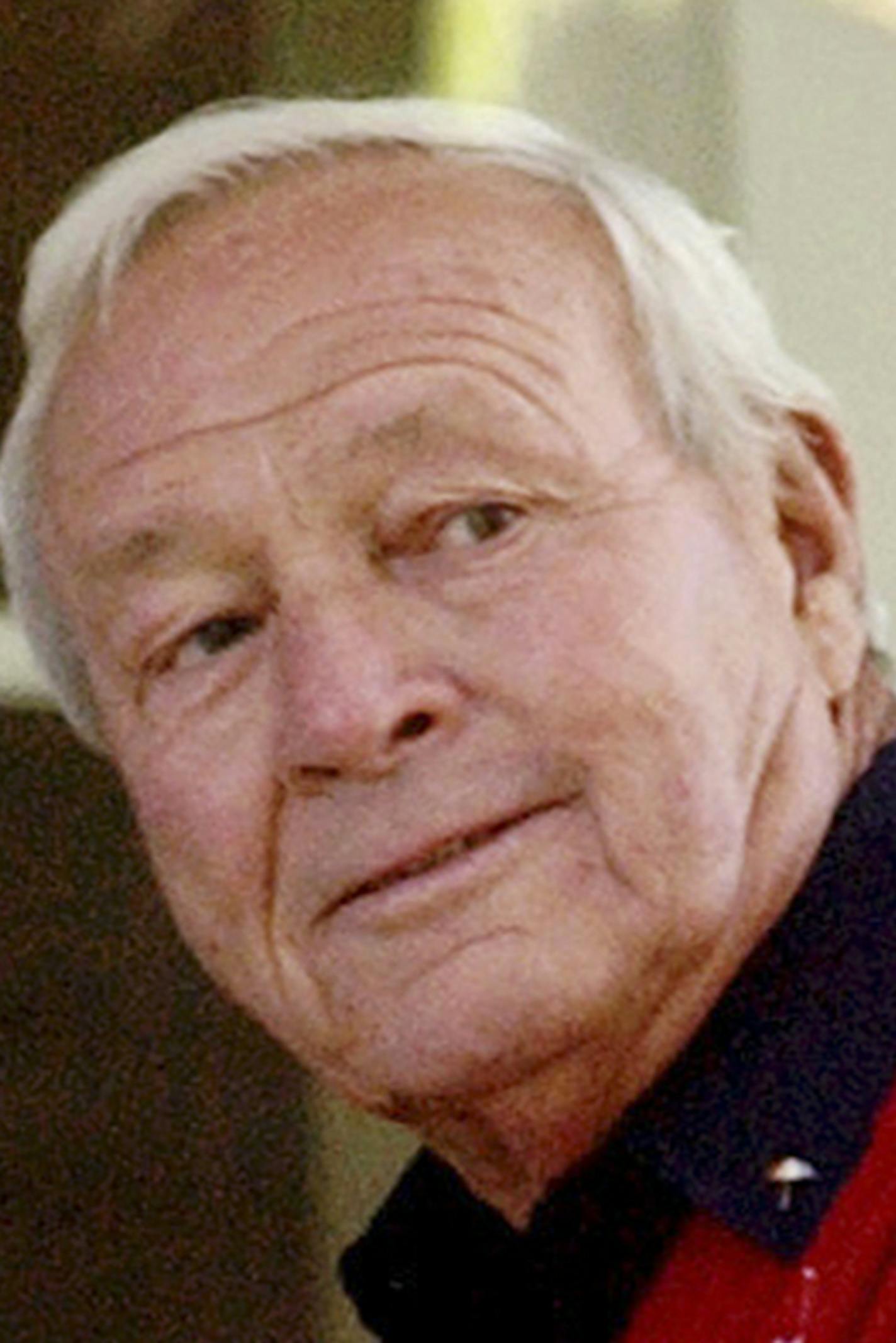 FILE--This 2004 file photo shows former Masters champion Arnold Palmer as he sits on clubhouse railing at the Augusta National Golf Club in Augusta, Ga. Palmer, who made golf popular for the masses with his hard-charging style, incomparable charisma and a personal touch that made him known throughout the golf world as "The King," died Sunday, Sept. 25, 2016, in Pittsburgh. He was 87. (AP Photo/David J. Phillip, File) ORG XMIT: MIN2016092611324809