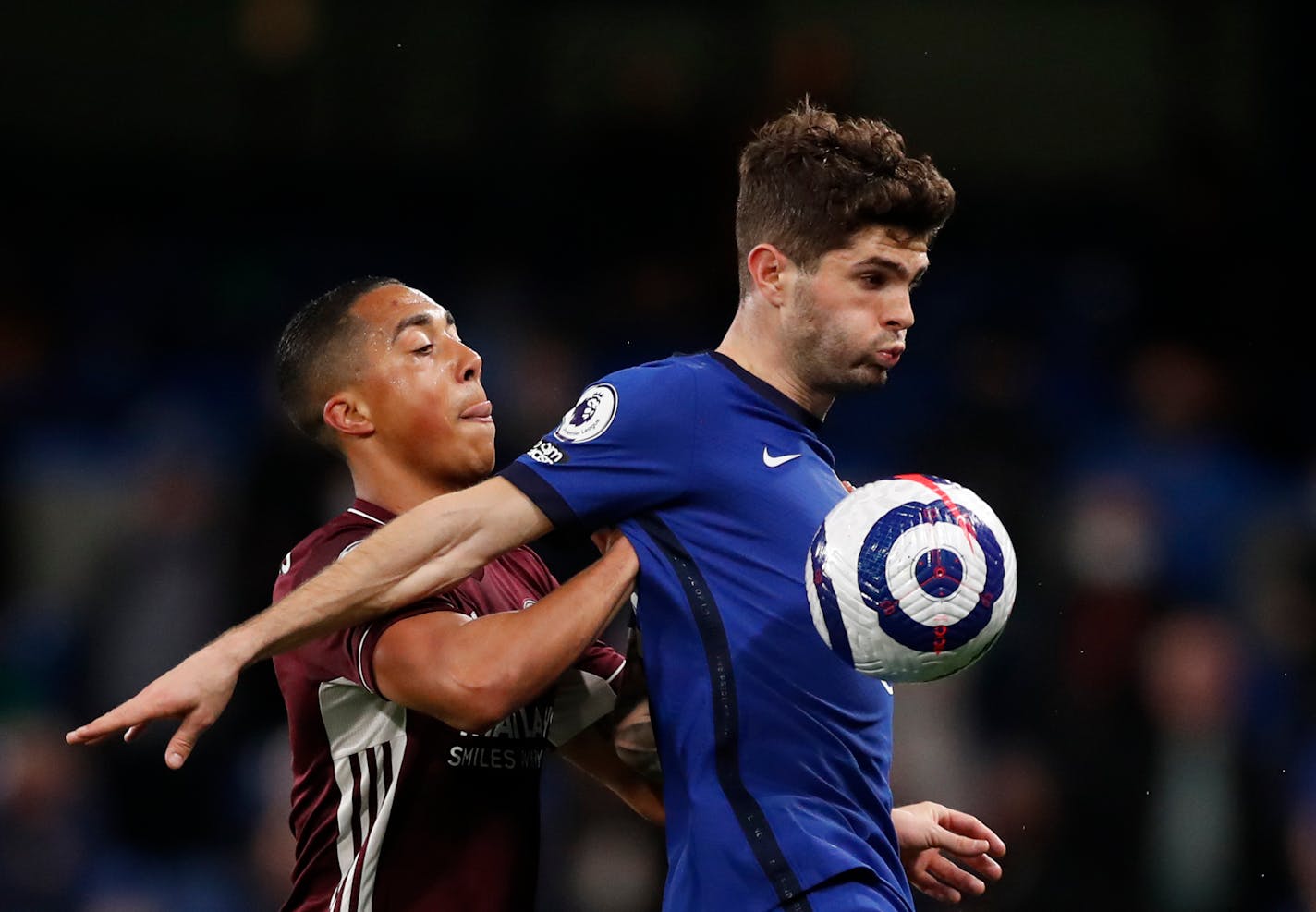 Leicester's Youri Tielemans, left, duels for the ball with Chelsea's Christian Pulisic