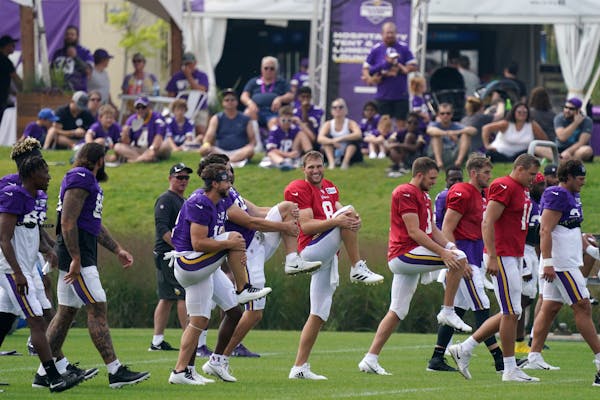 Vikings fans watched as quarterback Kirk Cousins (8) led the team in stretches during training camp last year.