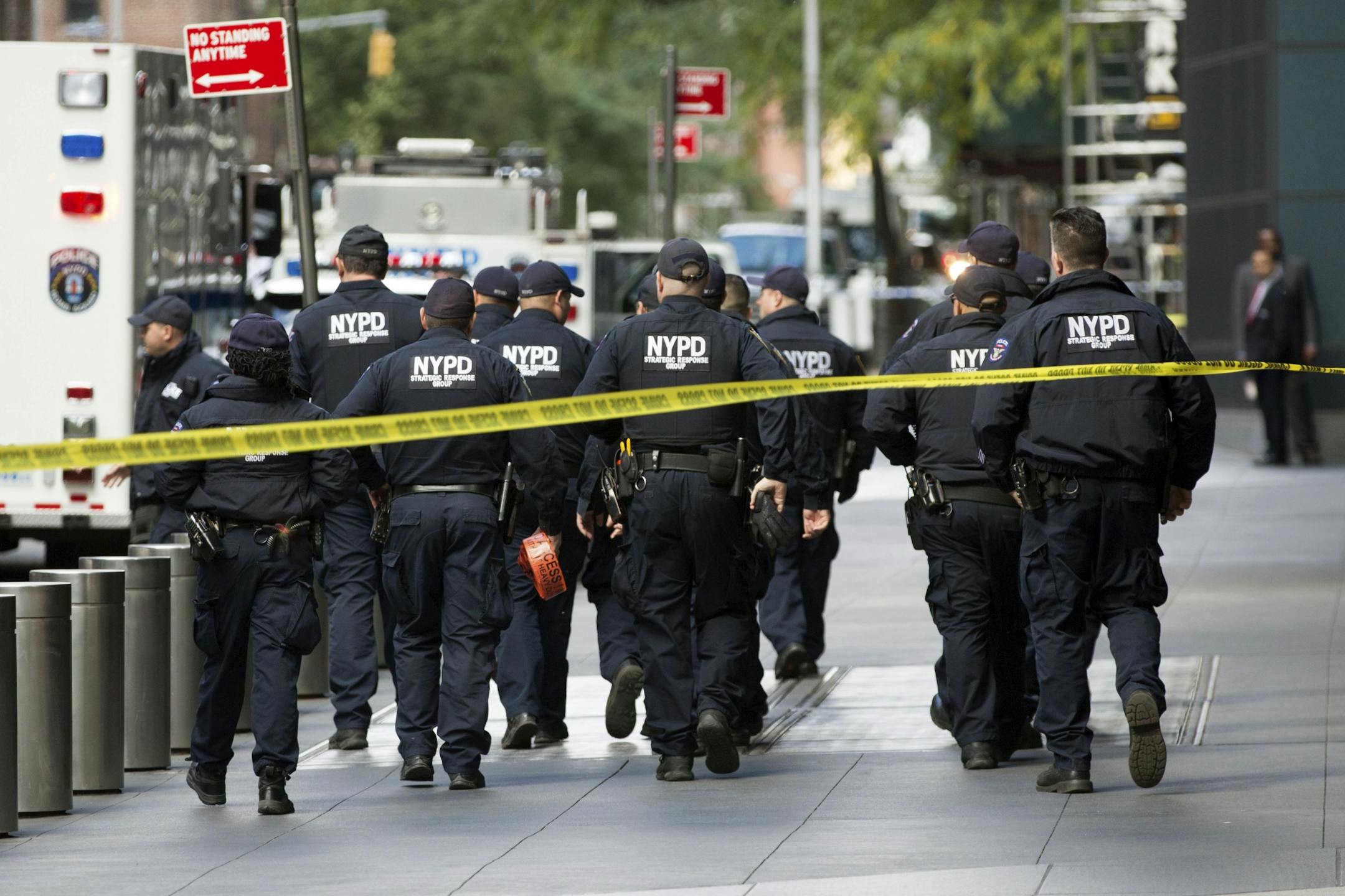 NYPD officers depart from the Time Warner Center area on Wednesday, Oct. 24, 2018, in New York. Law enforcement officials say a suspicious package that prompted an evacuation of CNN's offices is believed to contain a pipe bomb.