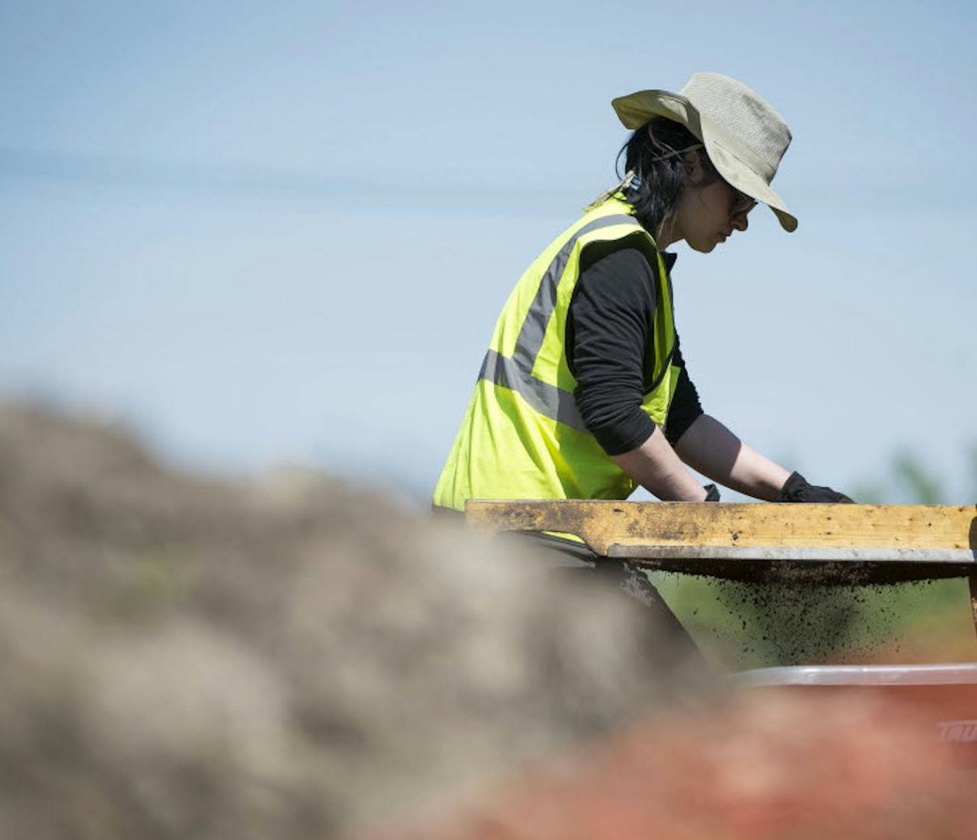 Hamline University alumna Desiree Haggberg used a screener to check for remains at the site of Native American burial mounds in Minnetonka in May 2015.