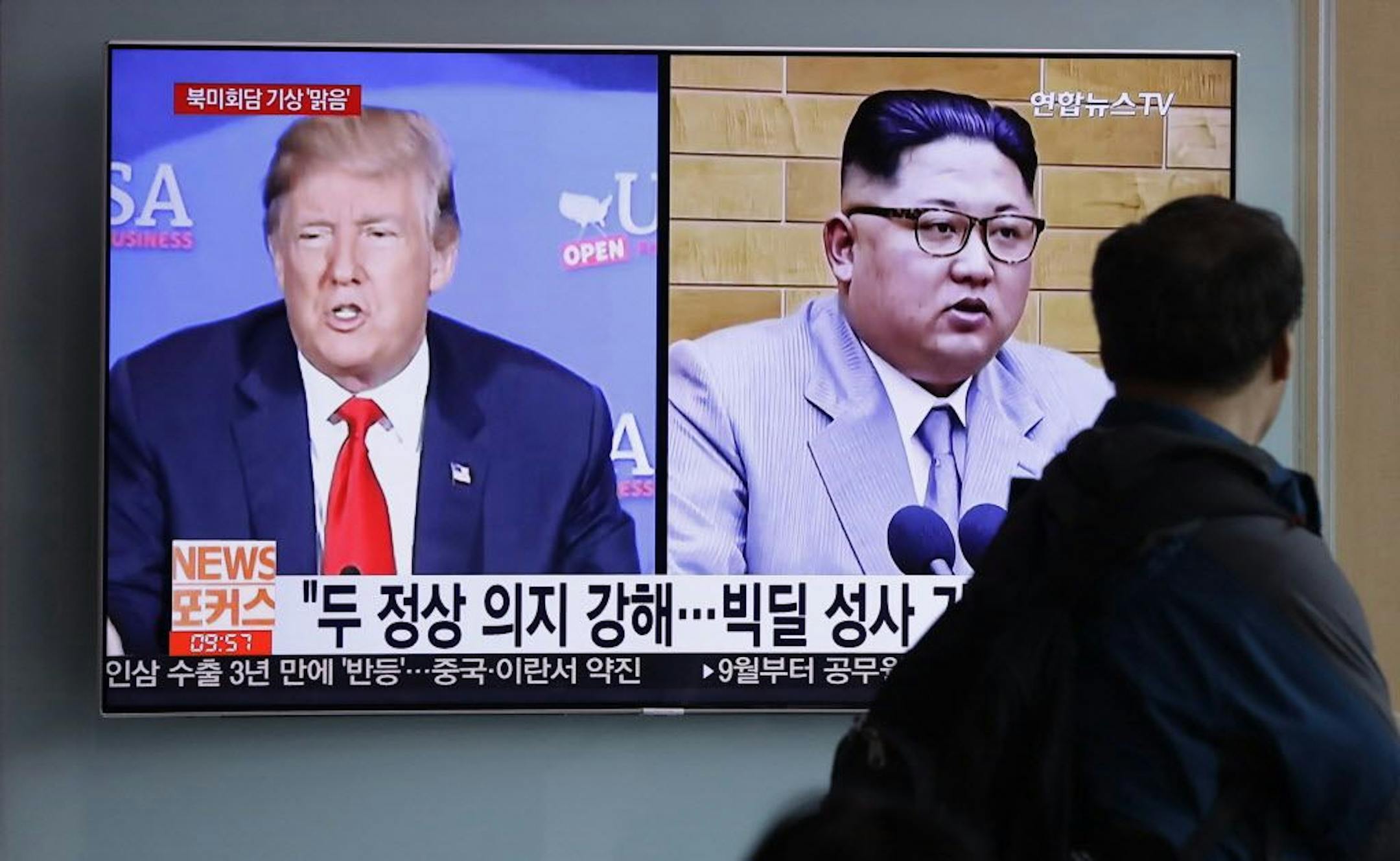 FILE - In this May 11, 2018, file photo, a man watches a TV screen showing file footage of U.S. President Donald Trump, left, and North Korean leader Kim Jong Un with onscreen letters reading "Summit between U.S. and North Korea, Forecast, Clear." during a news program at the Seoul Railway Station in Seoul, South Korea. North Korea's Foreign Ministry said Saturday May 12, 2018, it will hold a "ceremony" for the dismantling of its nuclear test site on May 23-25 in what would be a dramatic but sym