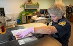 Leigh McCoy, central service admin senior lead, demonstrates the new system of making copies of mail addressed to offenders Tuesday, Jan. 9, 2023 at M
