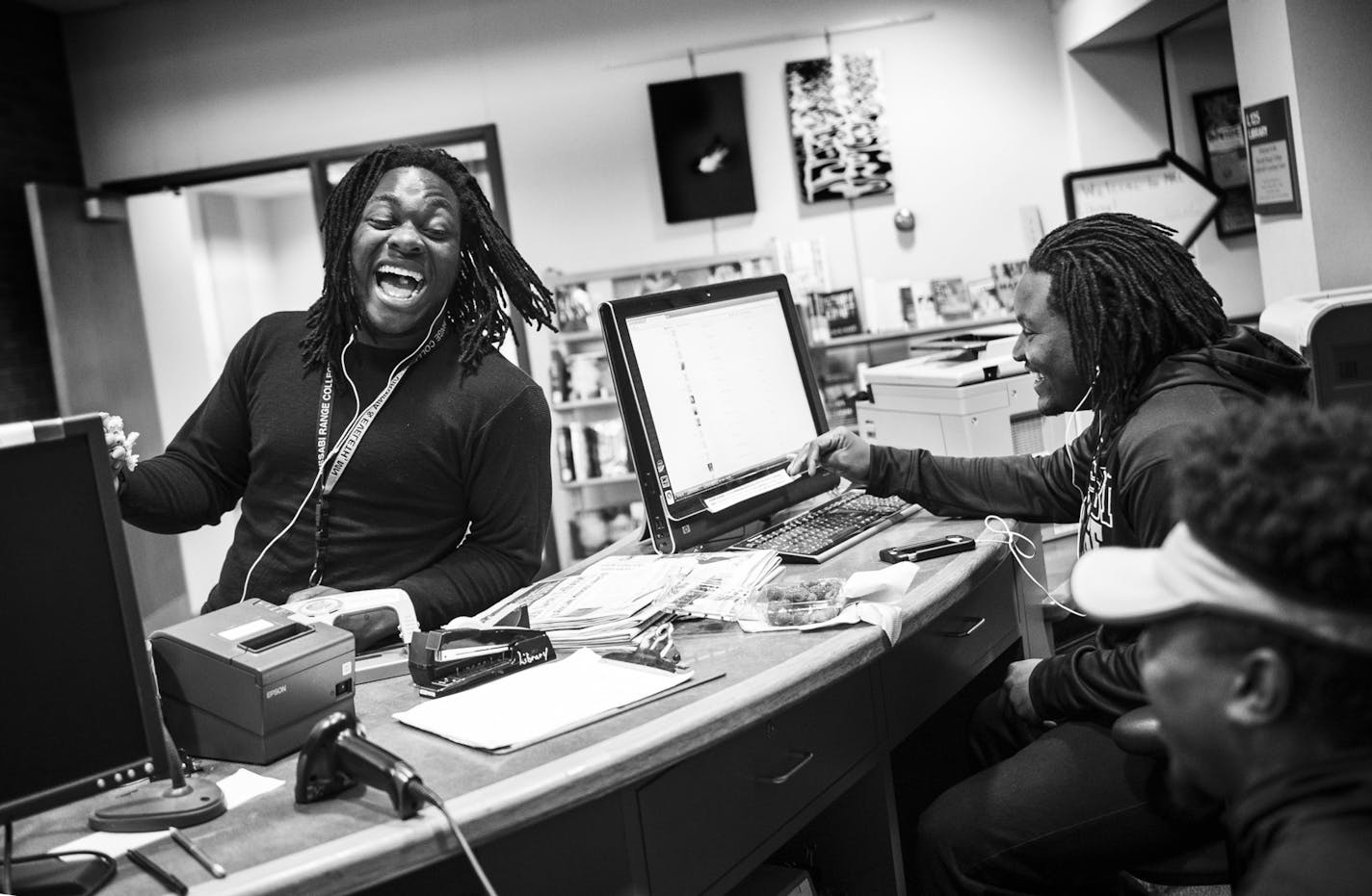 Teammates Elvin Turner, left, laughed while talking about girls with Kalil Grice and Benjamin Allen in the library of Mesabi Range College. As part of work study, the three work as library aides during the school year. ] Aaron Lavinsky &#x2022; aaron.lavinsky@startribune.com Photos to accompany a story on the Mesabi Range College Football team in Virginia, Minnesota. The team, which consists mostly of black athletes recruited from around the country, struggles to find its place in mostly-white m