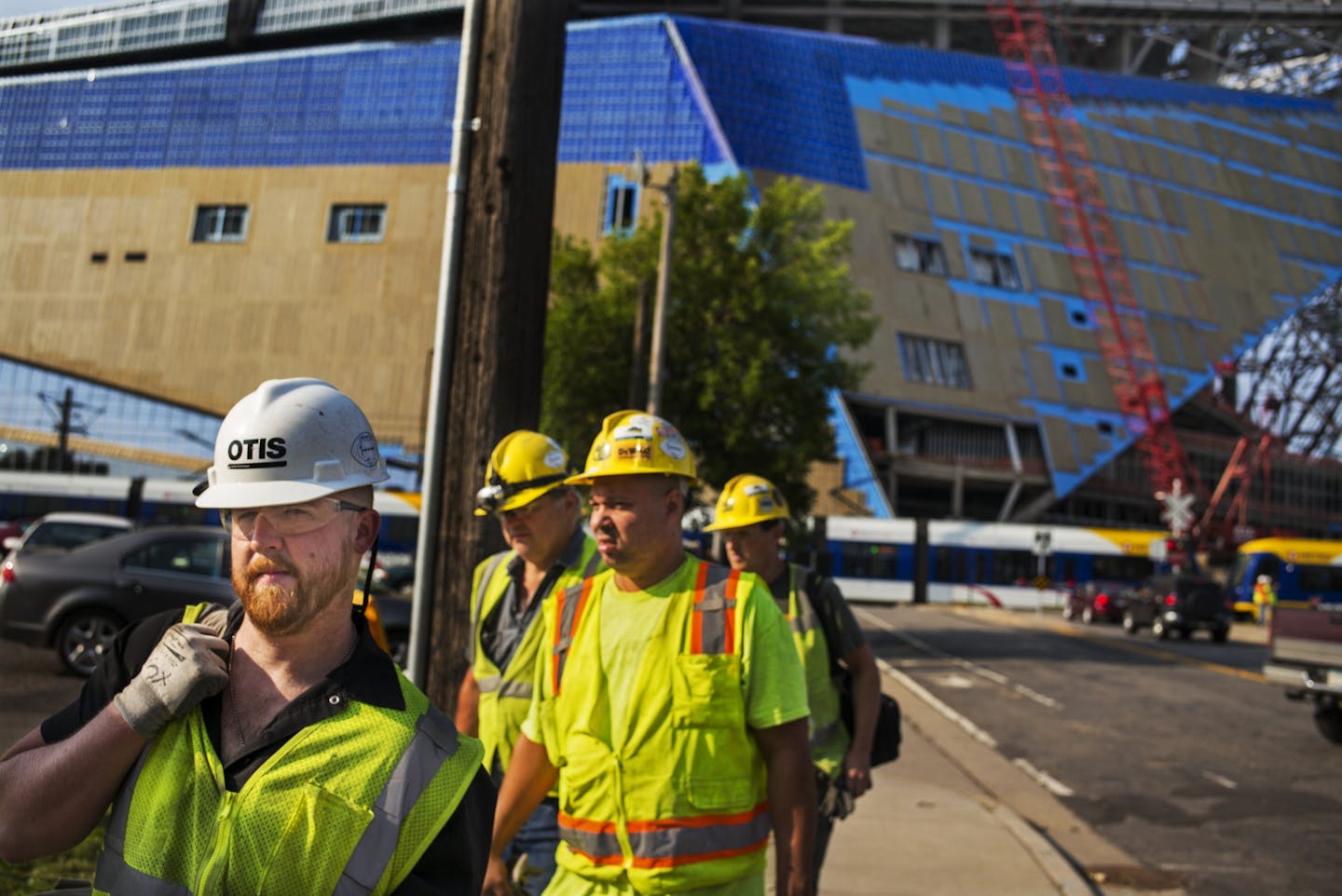 At U.S. Bank Stadium, workers leave the job site after one worker was killed and another injured in a fall Wednesday morning, Aug. 26, 2015.