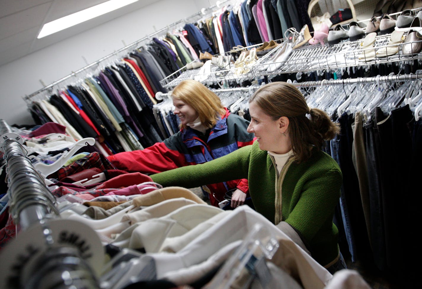 Karen Heimdahl, right, and Anne Wittnebel browsed the racks of used clothes at the Prop Shop in Eden Prairie. Heimdahl joined the Compact last April. "It's really taught me patience," she said. "Solutions will come if I wait." And, says husband Andy, "Our pocketbook really looks much better."