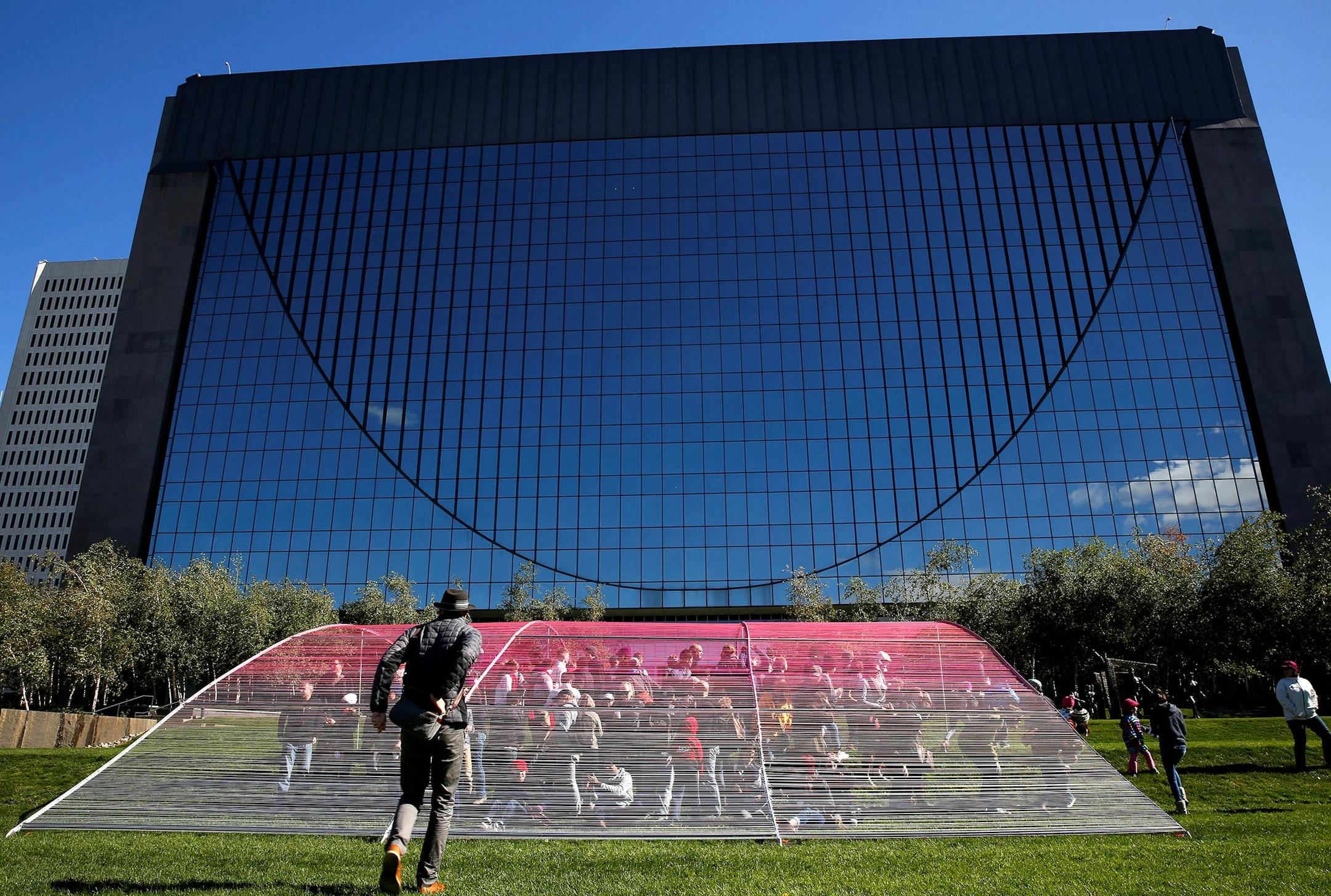 Minneapolis Instagramers, known as "Minnstagramers" gather for a group photo inside a yarn art installation by artist HOTTEA in Marquette Plaza's Cancer Survivor Park in downtown Minneapolis during the 10th Worldwide InstaMeet. ] LEILA NAVIDI leila.navidi@startribune.com / BACKGROUND INFO: The art was commissioned by Caribou Coffee and the nonprofit organization CancerCare and is located in Marquette Plaza's Cancer Survivor Park in downtown Minneapolis. Saturday, October 4, 2014.