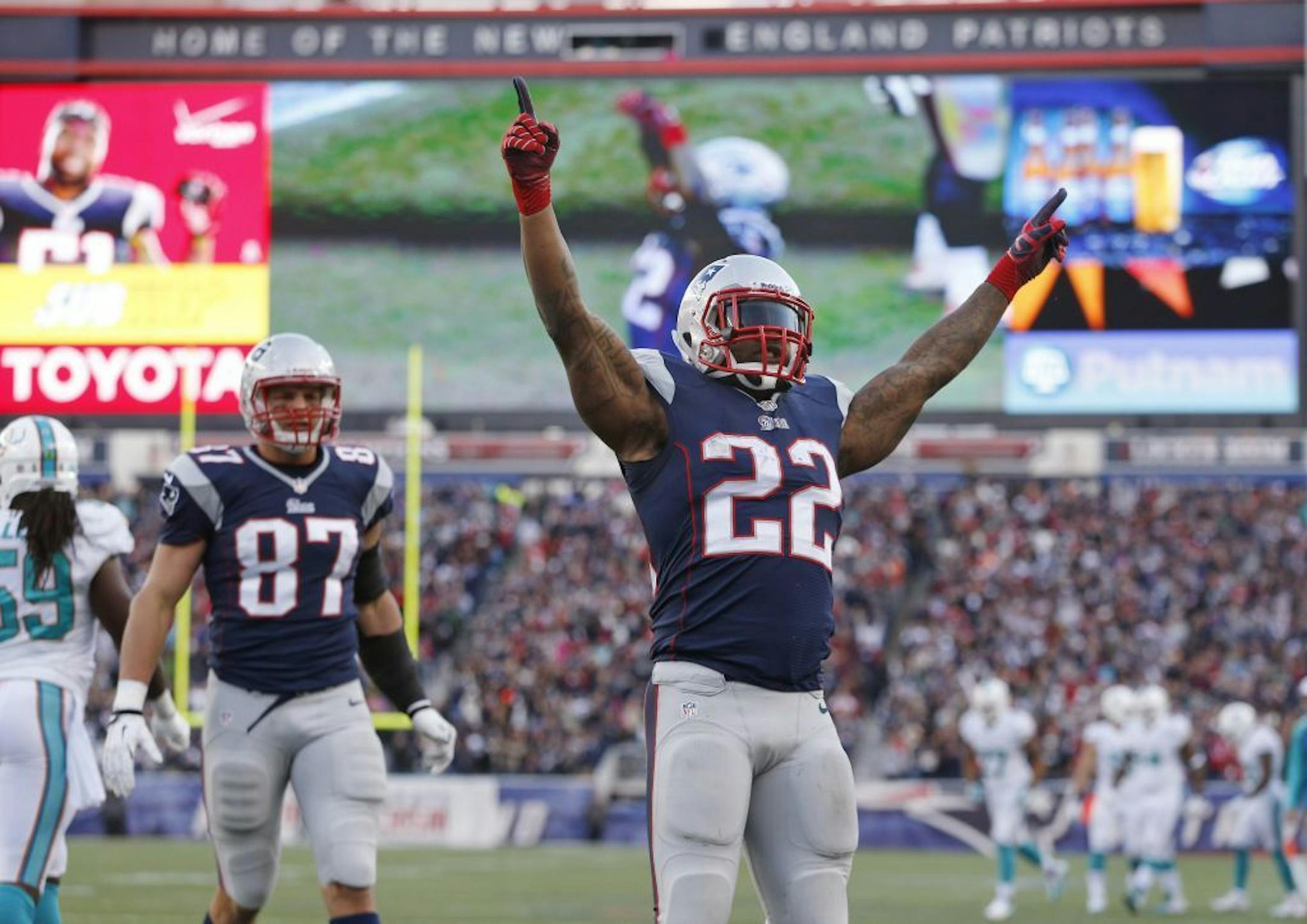 New England Patriots running back Stevan Ridley (22) celebrates his touchdown against the Miami Dolphins in the fourth quarter of an NFL football game Sunday, Oct. 27, 2013, in Foxborough, Mass. At left is Patriots tight end Rob Gronkowski.