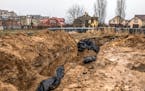 Bodies lie in a communal grave near the Church of St. Andrew in Bucha, Ukraine, on April 3.