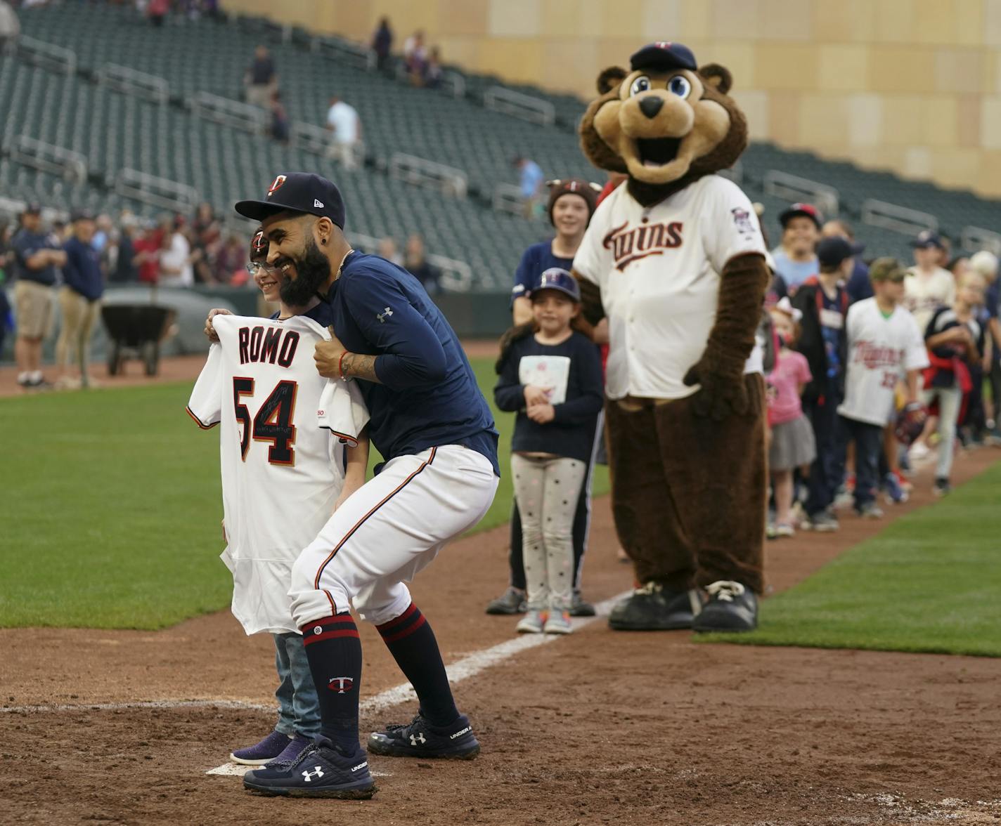 After the game, the Twins singed their jerseys and gave them away to kids waiting on the field. Twins' reliever Sergio Romo posed for a photo with the girl who received his. ] JEFF WHEELER &#x2022; jeff.wheeler@startribune.com The Minnesota Twins defeated the Kansas City Royals 12-8 in their final MLB home game of the regular season Sunday afternoon, September 22, 2019 at Target Field in Minneapolis.