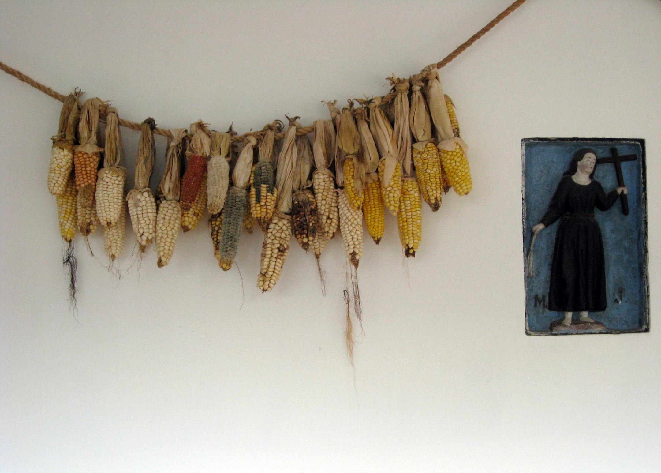 At Hacienda Cusin, a restored 17th-century estate in the Ecuadoran Highlands, signs of pre- and post-Spanish conquest can be found on a wall displaying dried corn and Christian art.