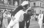 FILE - In this Aug. 14, 1945 file photo provided by the U.S. Navy, a sailor and a woman kiss in New York's Times Square, as people celebrate the end o