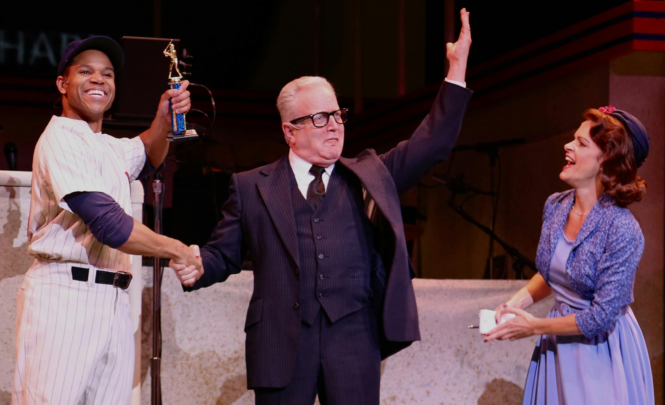 Thay Floyd as Joe Hardy, Gary Briggle as the commissioner and Kersten Rodau as Gloria Thorpe in the Ordway’s “Damn Yankees.”