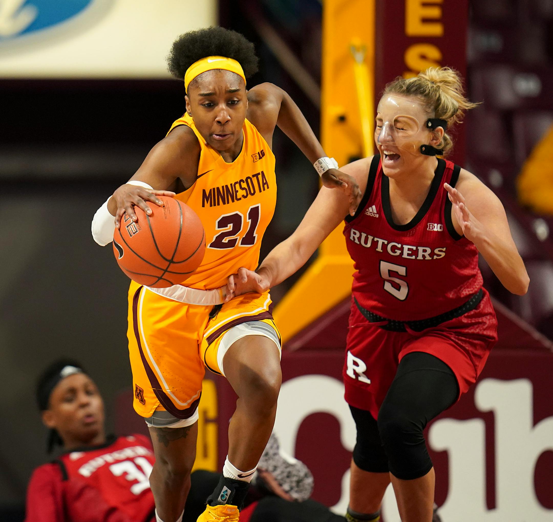 Minnesota Gophers guard Jasmine Brunson (21) stripped the ball from Rutgers Scarlet Knights guard Danielle Migliore (5) in the second quarter.