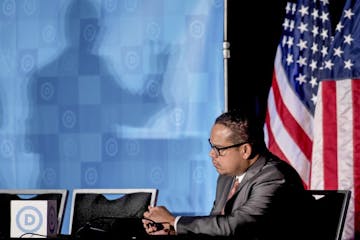 Rep. Keith Ellison, D-Minn, listens as newly elected Democratic National Committee Chairman Tom Perez gives a victory speech during the general sessio