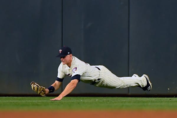 Minnesota Twins right fielder Max Kepler (26) made a diving catch for a foul ball hit by Boston Red Sox designated hitter J.D. Martinez (28) in the to