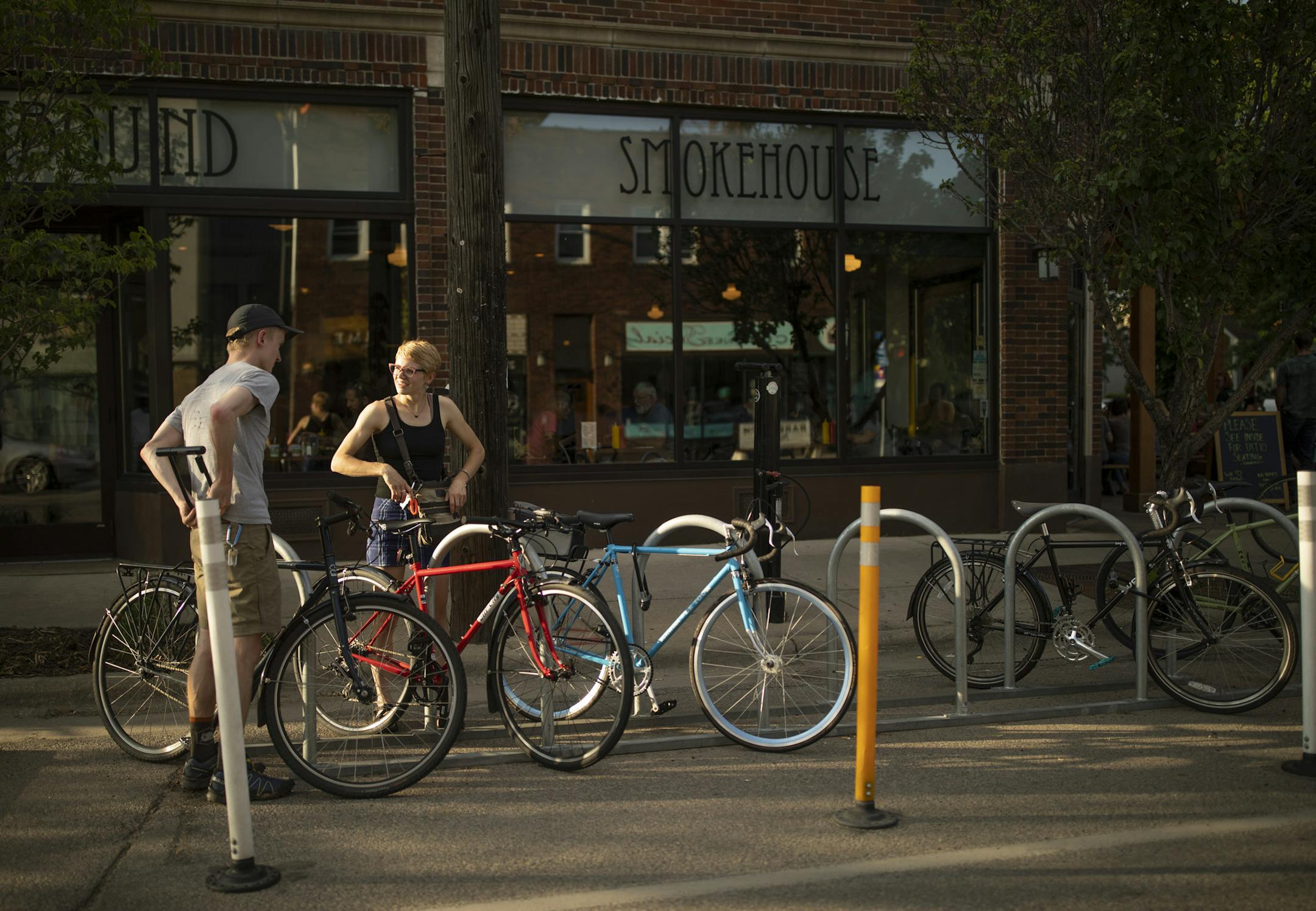 Weston Lofdahl and Nicolette Reker unlocked their bikes after stopping at the Northbound Thursday evening. ] JEFF WHEELER ï jeff.wheeler@startribune.com The Northbound Smokehouse and Brewpub in Minneapolis on 38th St. is a decidedly bike-friendly neighborhood watering hole. It was photographed Thursday evening, May 31, 2018.