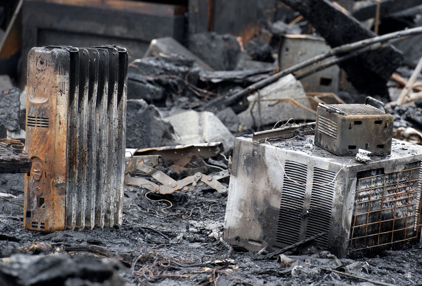 Some burned out space heaters in the garage where Donald Pnewski died in an early morning fire in the 800 block of Juno Avenue, St. Paul, Thursday, March 22, 2012. ] GLEN STUBBE * gstubbe@startribune.com ORG XMIT: MIN2015012712221460