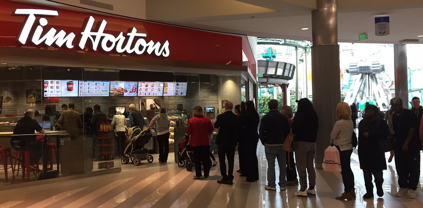 A line of customers goes out the door during the soft opening of the new Tim Hortons bakery at Mall of America, Novemer 15, 2016.