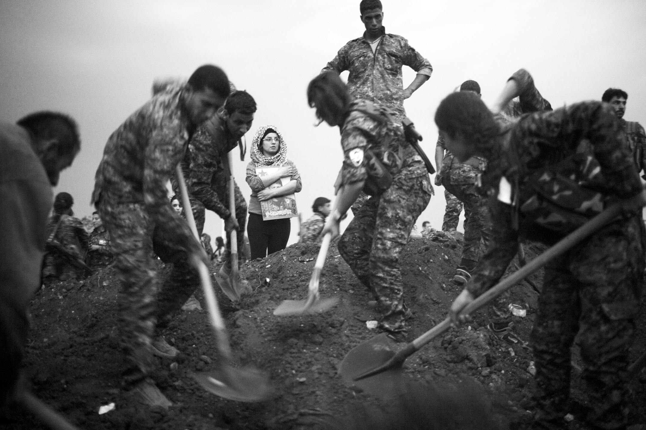 FILE -- Kurdish militia bury comrades who died fighting the Islamic State over a year ago and have only now been returned to their home town of Qamishli, Syria, Oct. 25, 2015. President Donald Trump's decision to pull troops from northern Syria upended a 5-year alliance with the Kurds and threw the operation against Abu Bakr al-Baghdadi into disarray. (Tyler Hicks/The New York Times)