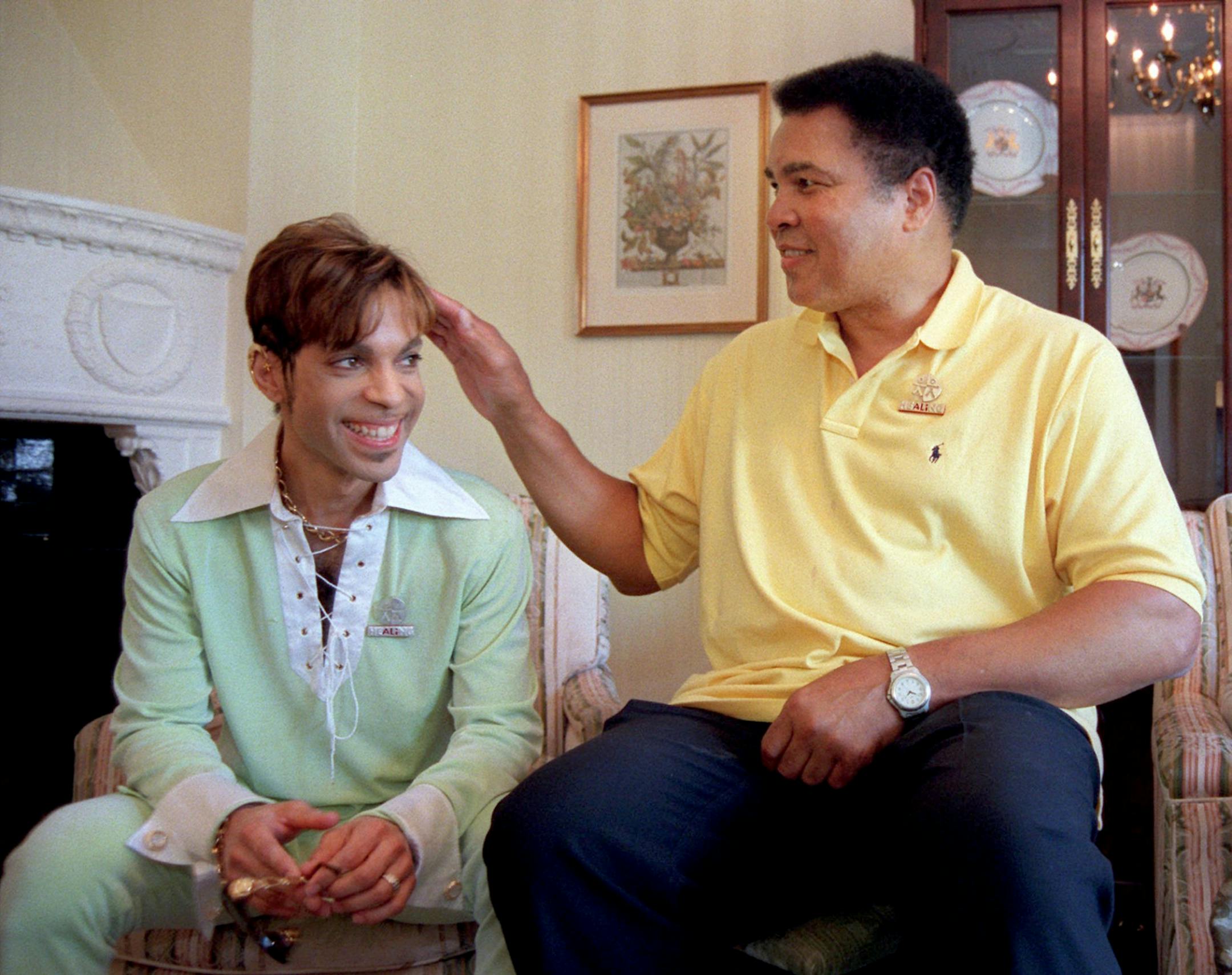 Boxing great Muhammad Ali, right, pats the head of the Artist Formerly Known as Prince during a meeting in Washington Tuesday, June 24, 1997 prior to a news conference where they were to announce plans for a benefit concert in October. The World Healing Honors will be a grand benefit concert to promote international harmony and tolerance.