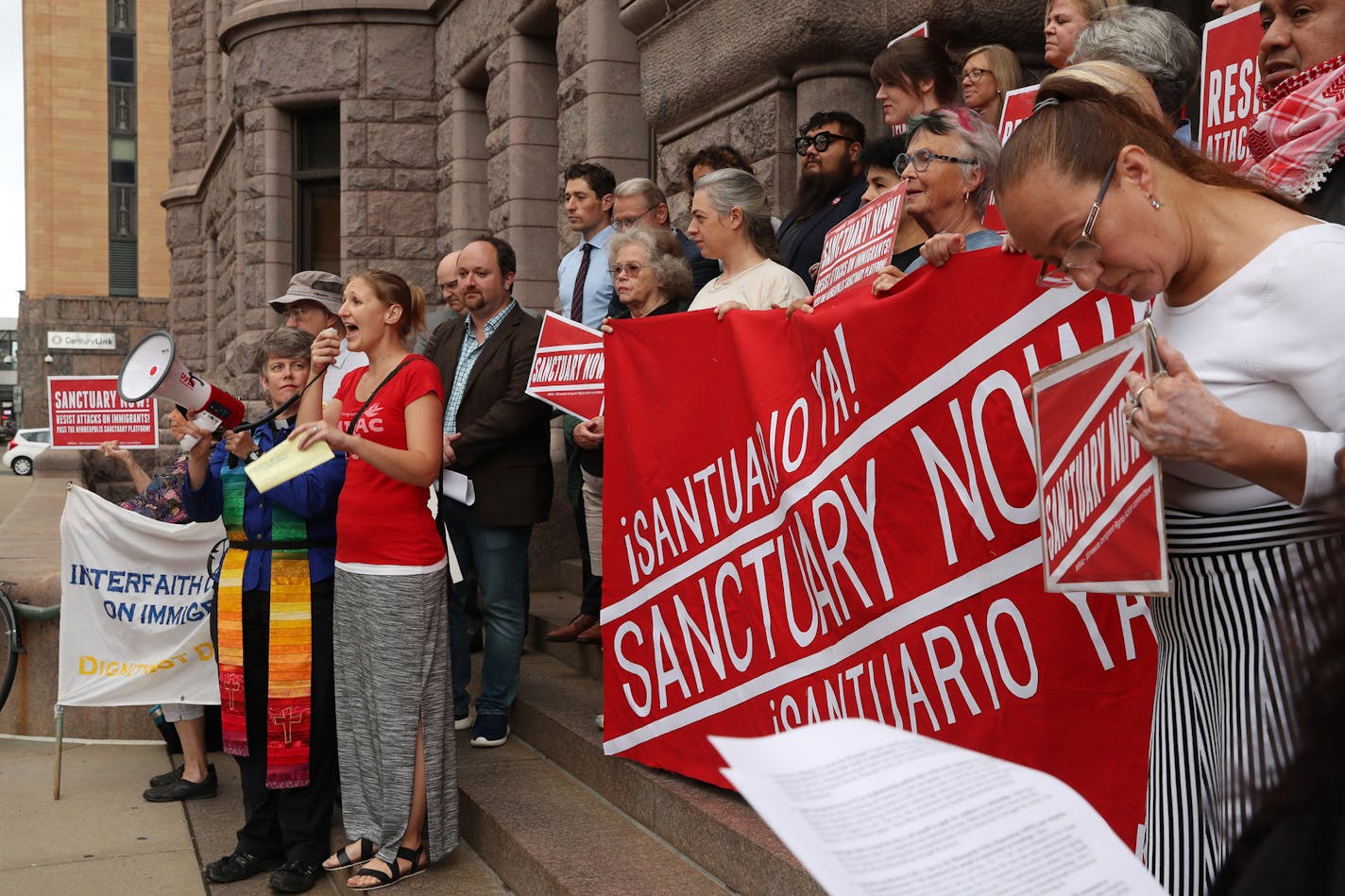 Erika Zurawski, left, of Minneapolis rallied immigration rights activists prior to the Minneapolis City Council meeting where they drew attention to a 13-point "Sanctuary Platform" on Wednesday morning.