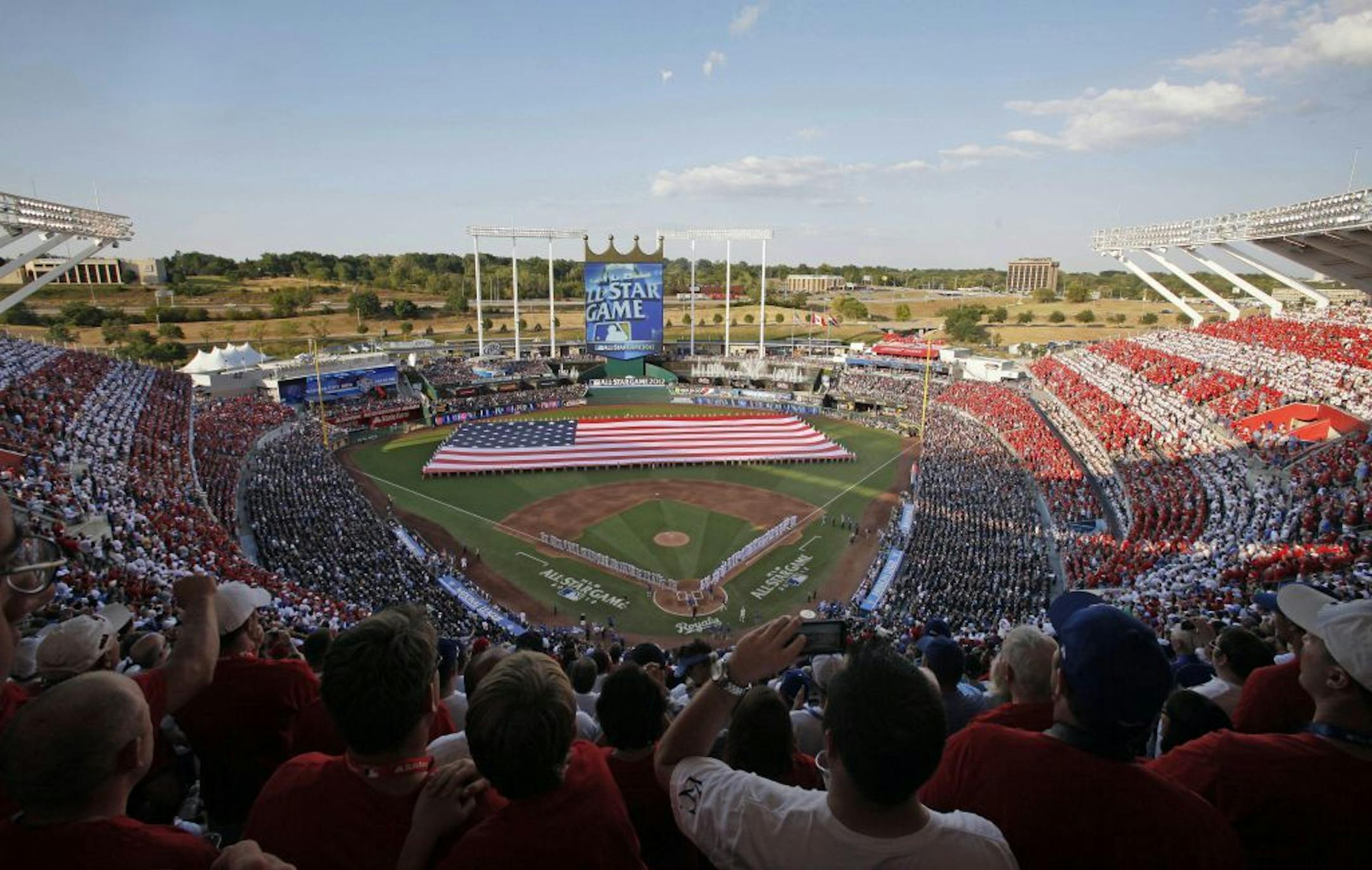Fans watch from the stands at Kauffman Stadium during the pregame of the MLB All-Star baseball game, Tuesday, July 10, 2012, in Kansas City, Mo.