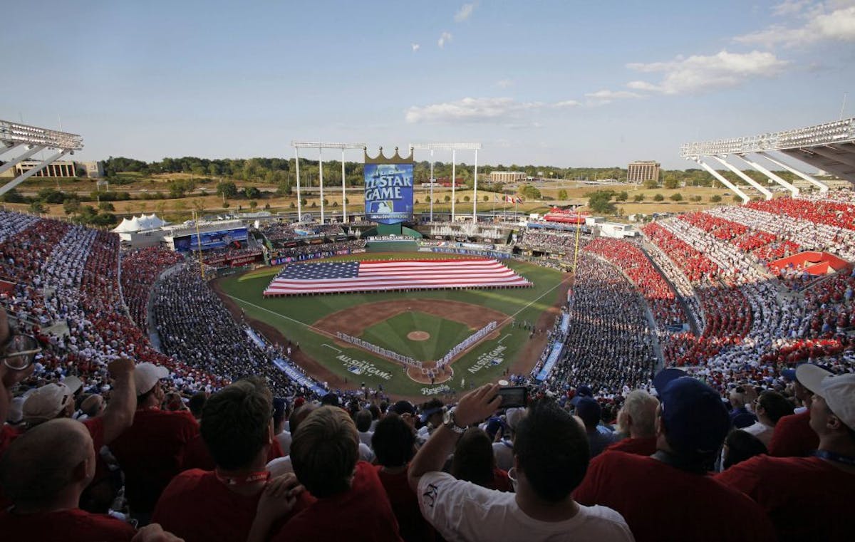 Fans watch from the stands at Kauffman Stadium during the pregame of the MLB All-Star baseball game, Tuesday, July 10, 2012, in Kansas City, Mo.