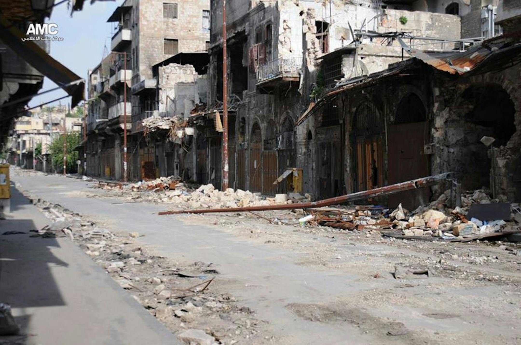 This citizen journalism image provided by Aleppo Media Center AMC which has been authenticated based on its contents and other AP reporting, shows damaged buildings during battles between the rebels and the Syrian government forces, in Aleppo, Syria, June 13, 2013.