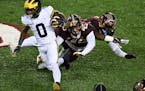 Minnesota Gophers defensive lineman MJ Anderson (3) and linebacker Cody Lindenberg (45) collided as they missed a tackle against Michigan Wolverines w