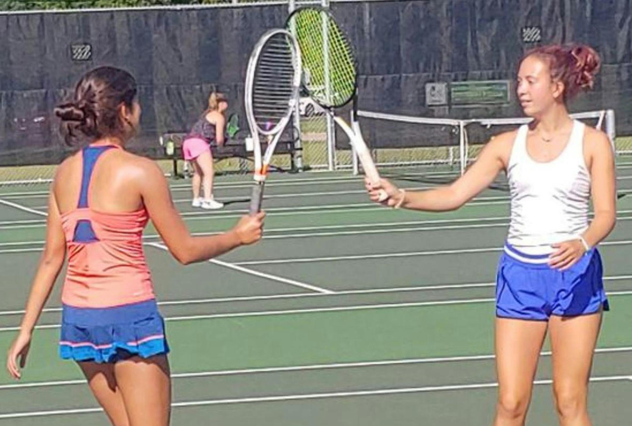 Edina tennis players Anna Martinez, left, and Lizzie Van Ert tapped racquets in lieu of a high five during practice Monday morning at the high school tennis courts. Photo: Jim Paulsen, Star Tribune