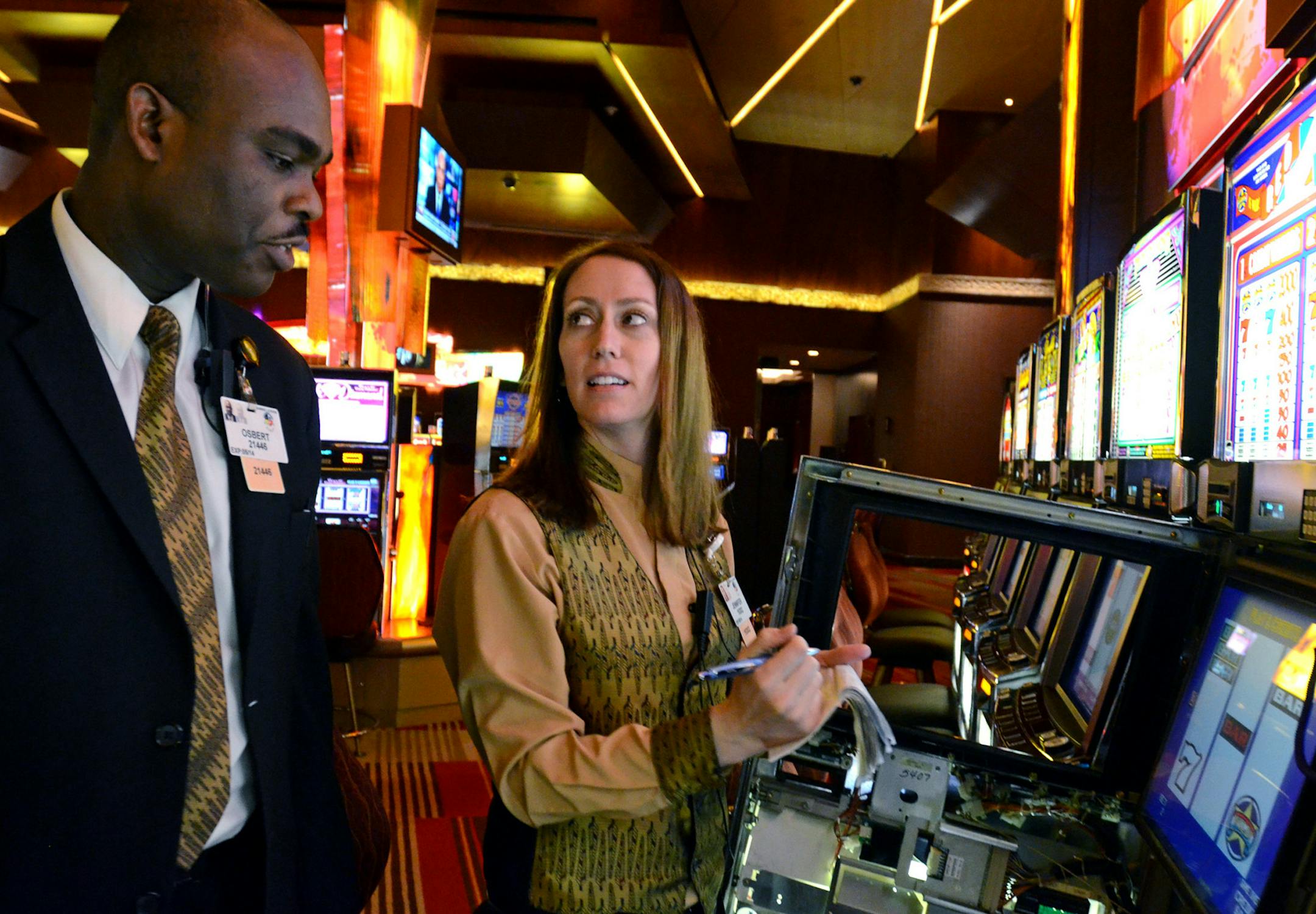 (Left to right) Osbert Austin, slot supervisor, and Jennifer Hallstrom, slot service specialist, work on one of the machines at Mystic Lake Casino.) ] Joey McLeister,Special to the Star Tribune,Prior Lake,MN May27,2013