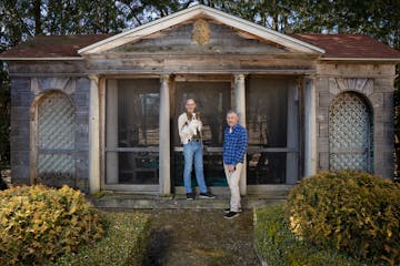 Tim Foster, holding 14-year-old Papillon Vince, and Bruce Schabell, in front of a Romanesque garden temple with a screen porch on March 6, 2024 that t