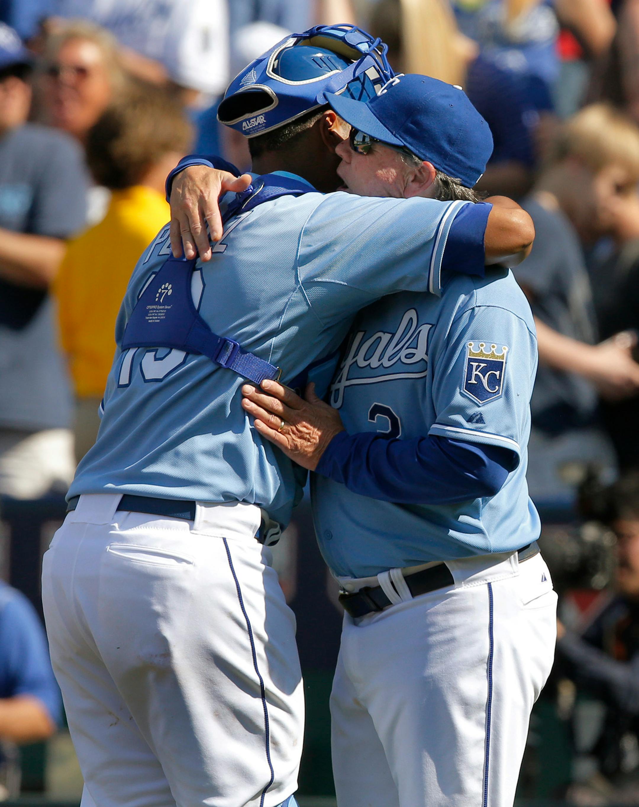 Kansas City Royals catcher Salvador Perez, left, gets a hug from manager Ned Yost following a baseball game against the Minnesota Twins at Kauffman Stadium in Kansas City, Mo., Saturday, April 19, 2014. The Royals defeated the Twins 5-4. (AP Photo/Orlin Wagner)