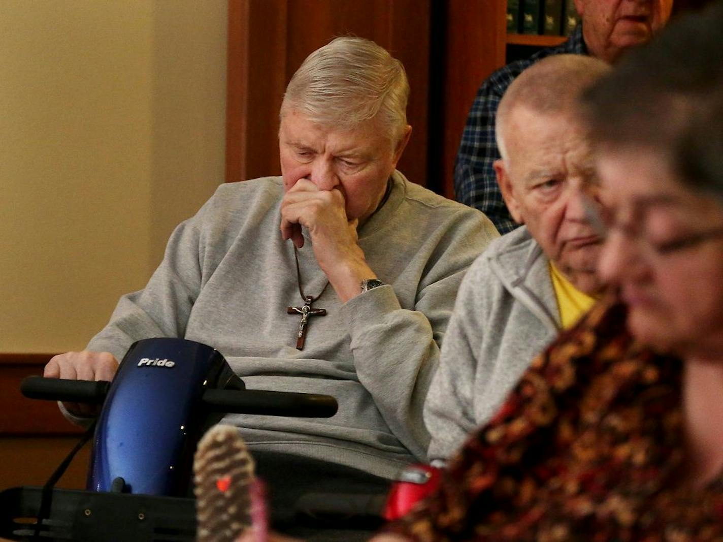 Autumn Glen residents, including Bill Erickson, left, and Jim Nauman, who both use motorized scooters, gathered to talk about their fears for the future after a 20 percent or more rent hike they received from management before Christmas.