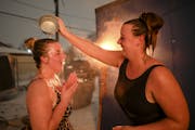 Hannah Peine, of St .Paul, poured water onto the head of her friend, Lindsey Hostetler, of Northfield, after they emerged from a sauna Thursday night.
