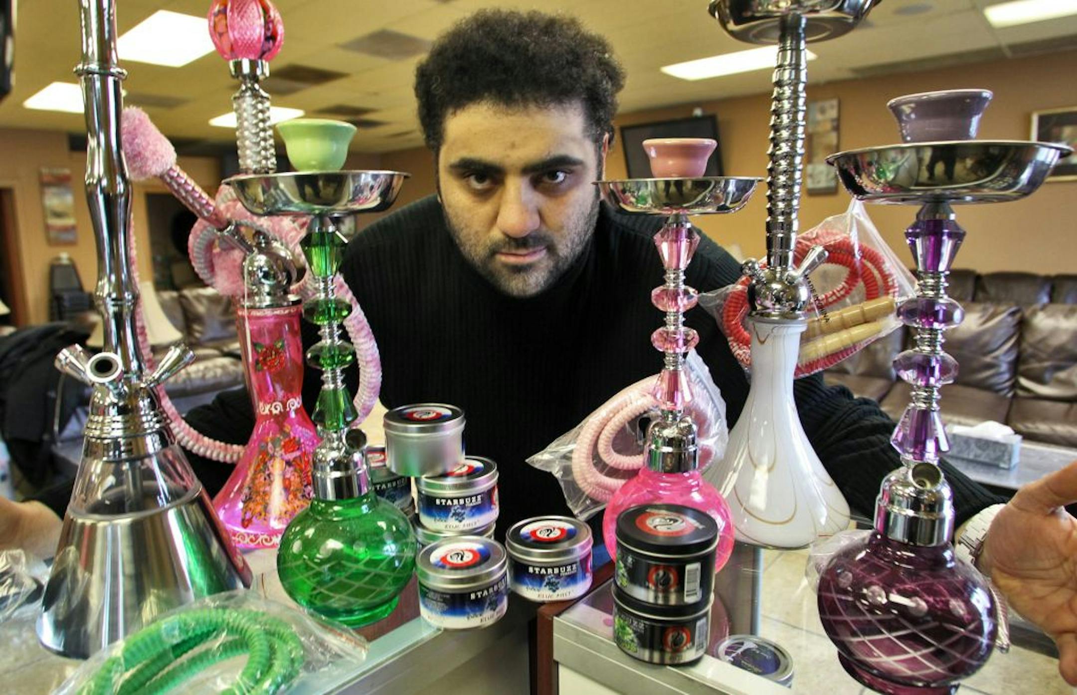 Saeed Kiblaewi is the owner of Flamezz, a hookah store in St. Anthony Village. He is having issues with the city council after they originally approved the opening of his store but now are seeking to close it. Here, Kiblaewi displayed a collection of hookahs and tobacco products for sale at his store.