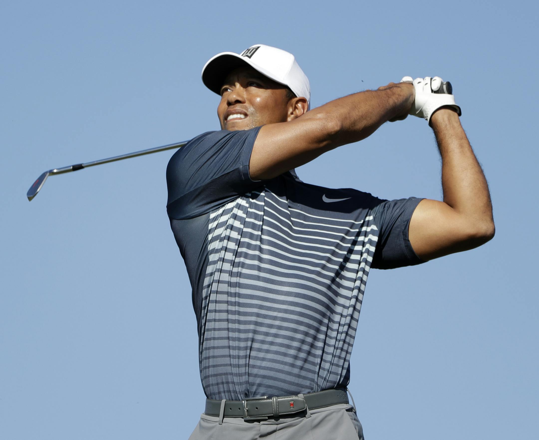 Tiger Woods watches his tee shot on the 15th hole on the North Course at Torrey Pines Golf Course during the second round of Farmers Insurance Open golf tournament Friday, Jan. 26, 2018, in San Diego. (AP Photo/Gregory Bull)