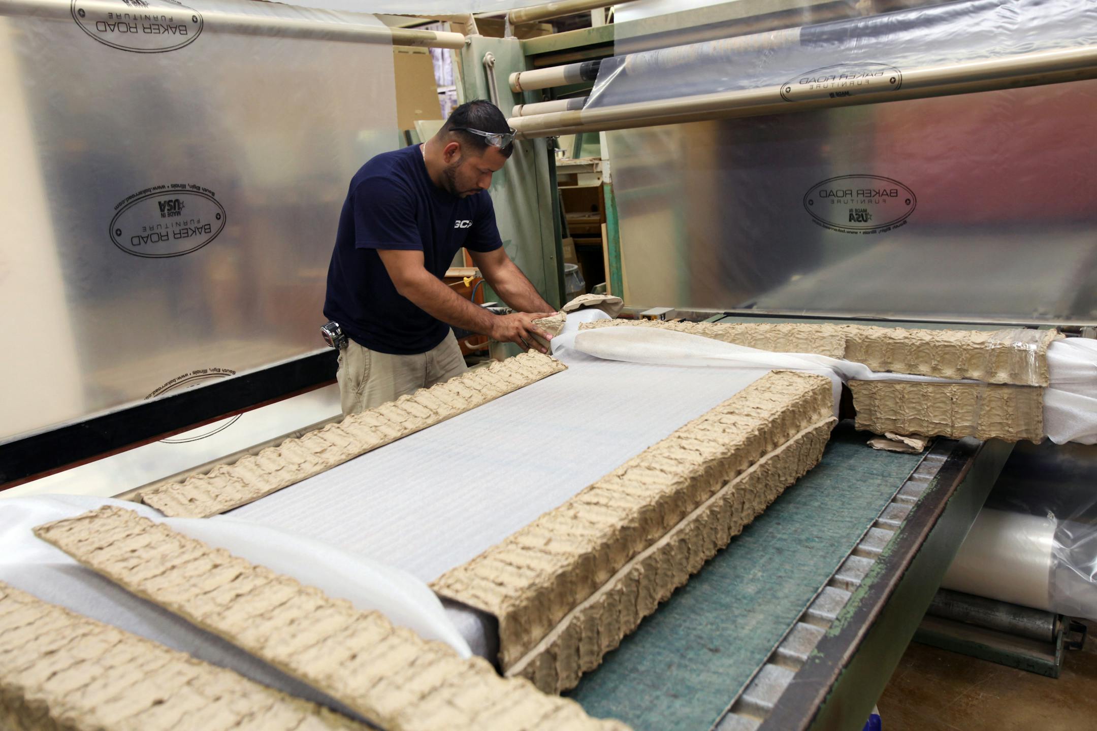 A worker prepares a custom piece of furniture for shipping at the at Baker Road Furniture manufacturing facility in South Elgin, Illinois, U.S., on Tuesday, Sept. 24, 2013. Treasuries erased gains after the U.S. said durable-goods orders rose in August from a drop the previous month that was bigger that initially reported. Photographer: Tim Boyle/Bloomberg