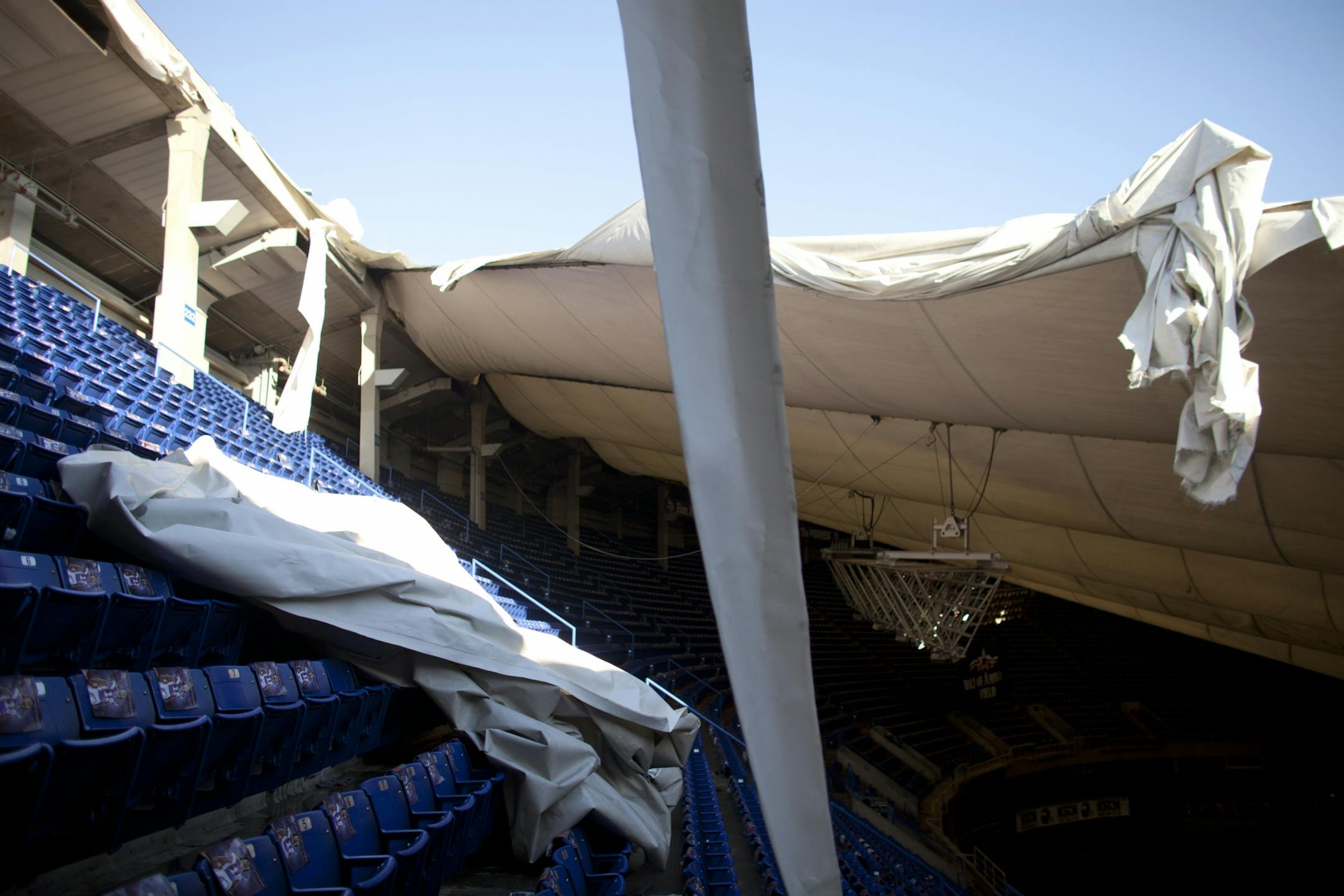 A torn portion of the Metrodome roof landed on some seats in the upper deck.