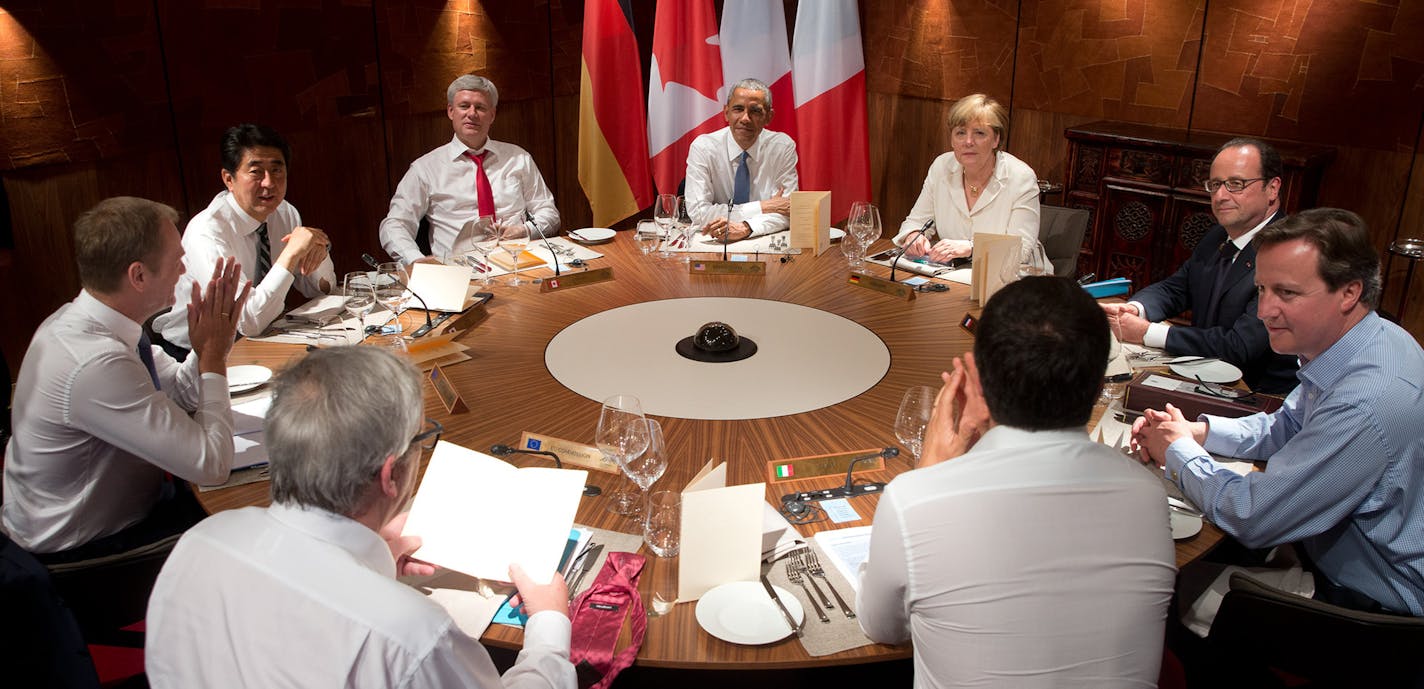 Left to right clockwise, European Council President Donald Tusk, Japanese Prime Minister Shinzo Abe, Canadian Prime Minister Stephen Harper, US President Barack Obama, German Chancellor Angela Merkel, French President Francois Hollande, British Prime Minister David Cameron, Italian Premier Matteo Renzi, and European Commission President Jean-Claude Juncker, sit together for a working dinner during the G-7 summit in Schloss Elmau hotel near Garmisch-Partenkirchen, southern Germany, Sunday, June 7