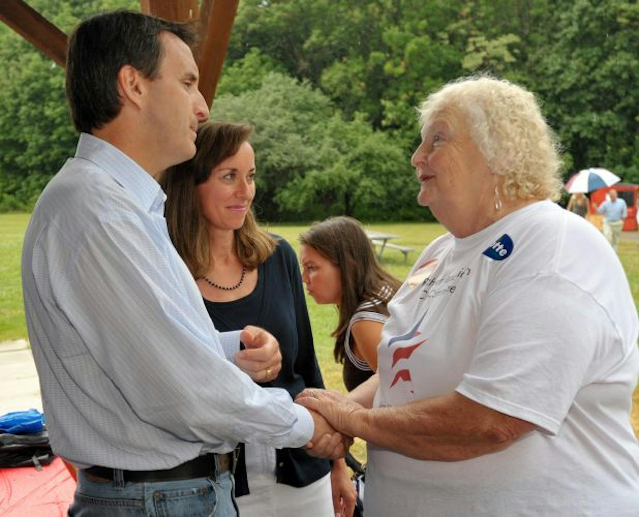 Alongside his wife Mary, Gov. Tim Pawlenty, R-Minn., is greeted by New Hampshire State Rep. Julie Brown, R-Rochester, at the GOP picnic in Dover, N.H. Saturday July 10, 2010.