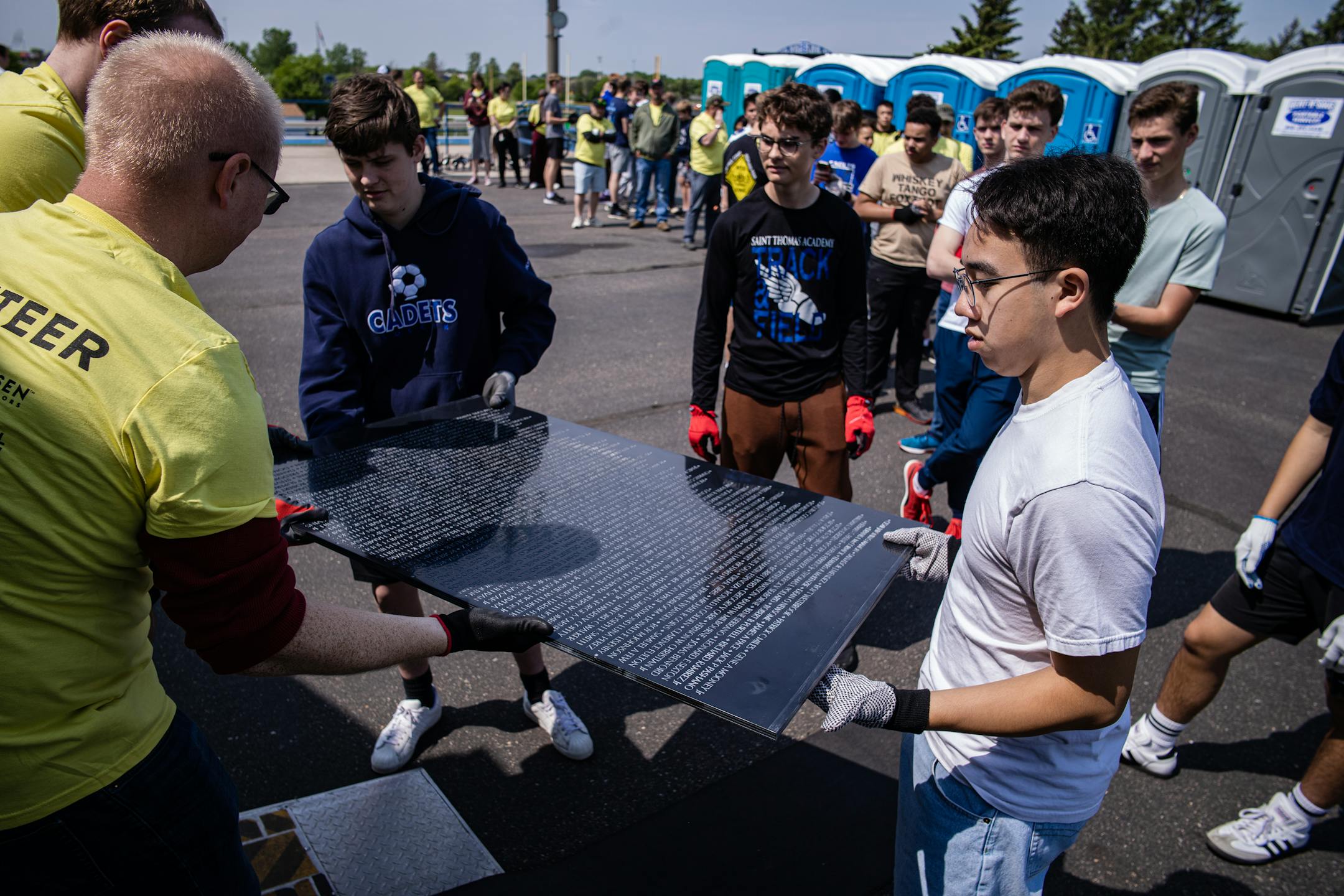 St. Thomas Academy cadets and volunteers help assemble a 3/4 scale of the Wall That Heals that contains 58,281 names of Vietnam Veterans who died in combat, including Richard Walsh III, in Mendota Heights, Minn., on Thursday, May 25, 2023. The replica of the Vietnam wall will be on display through the weekend.