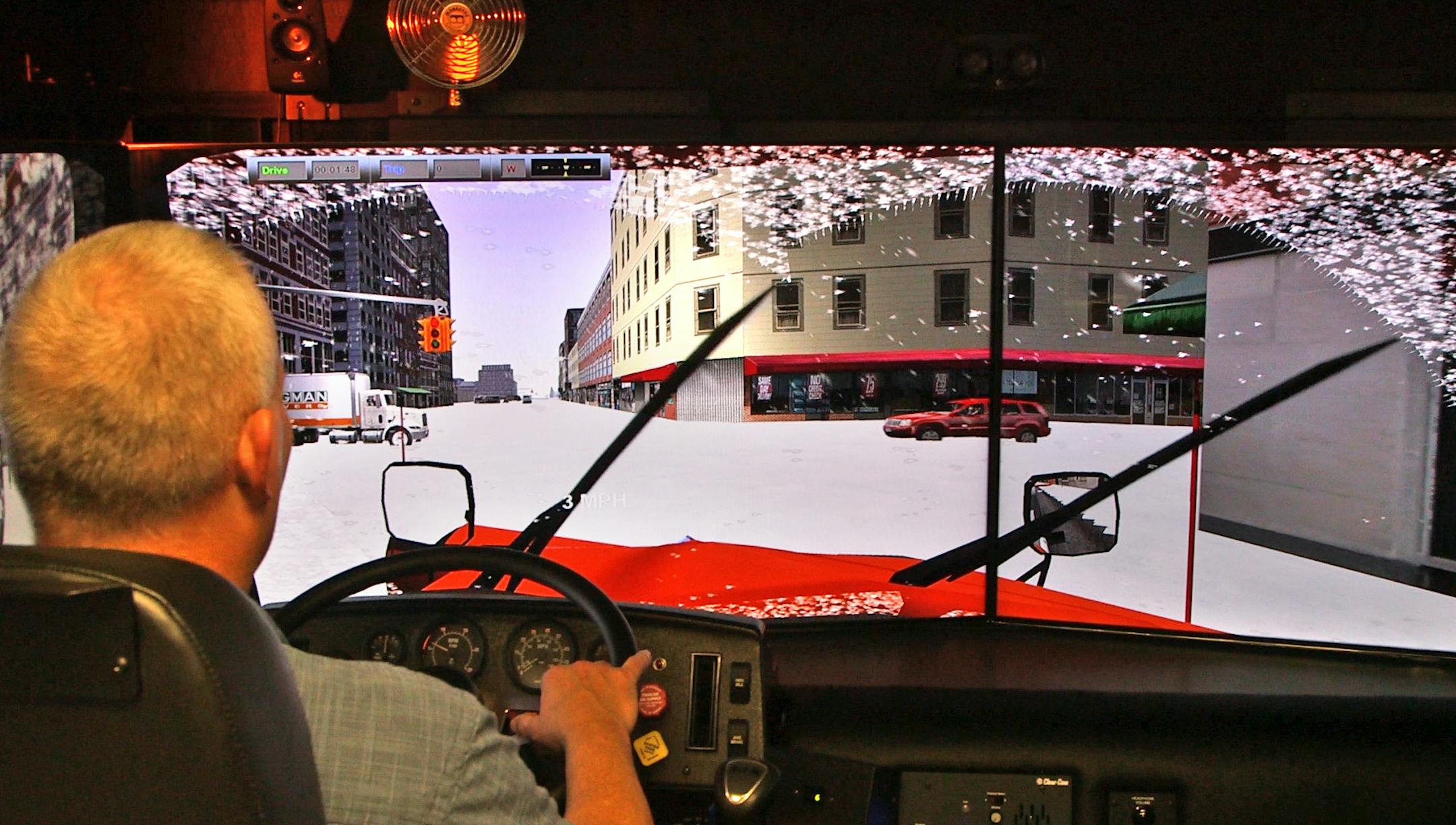 Andrew Kubista, snow plow simulator program manager, demonstrates the simulator Tuesday, Jan. 26, 2016. Photo: Matt Gillmer.