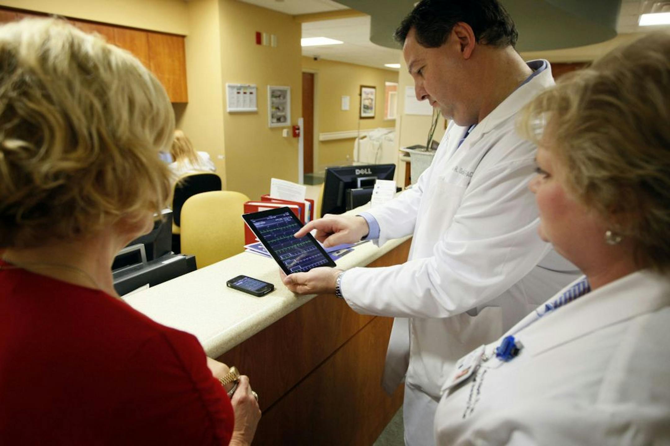Cardiologist Dr. Jose Soler early this month used an app on an iPad to review medical tests of one of his patients at Northwest Medical Center in Margate, Fla.
